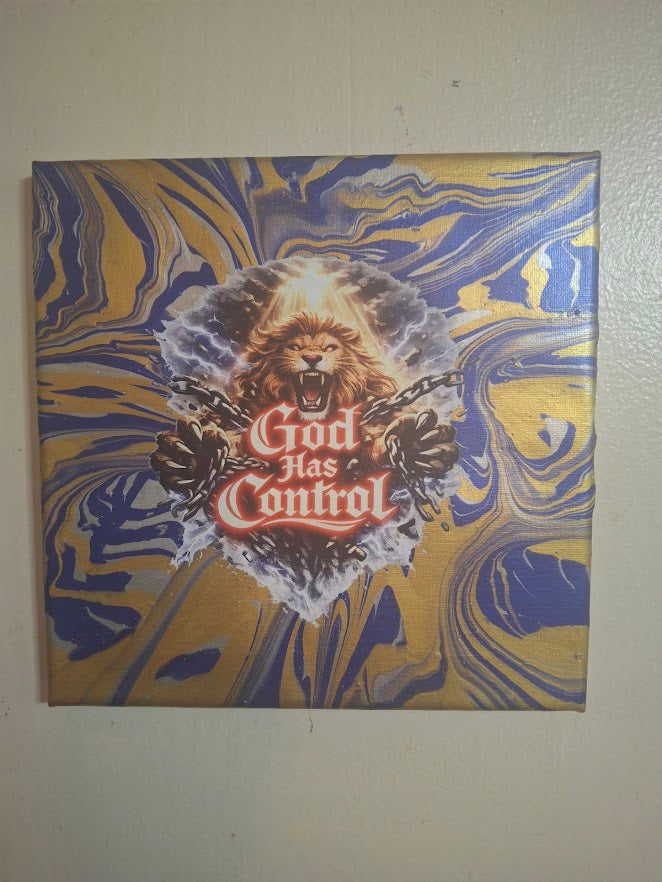 Canvas print with a lion and 'God Has Control' text on a marbled blue and gold background.